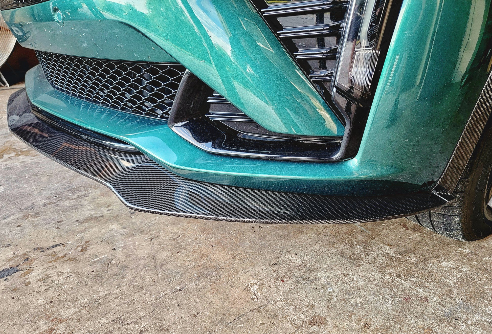 Cadillac 2025 2026 CT5-V CT5V front chin lip front splitter in Carbon Fiber or Gloss Black Fiberglass. OEM + American Aftermarket Upgrade Mods